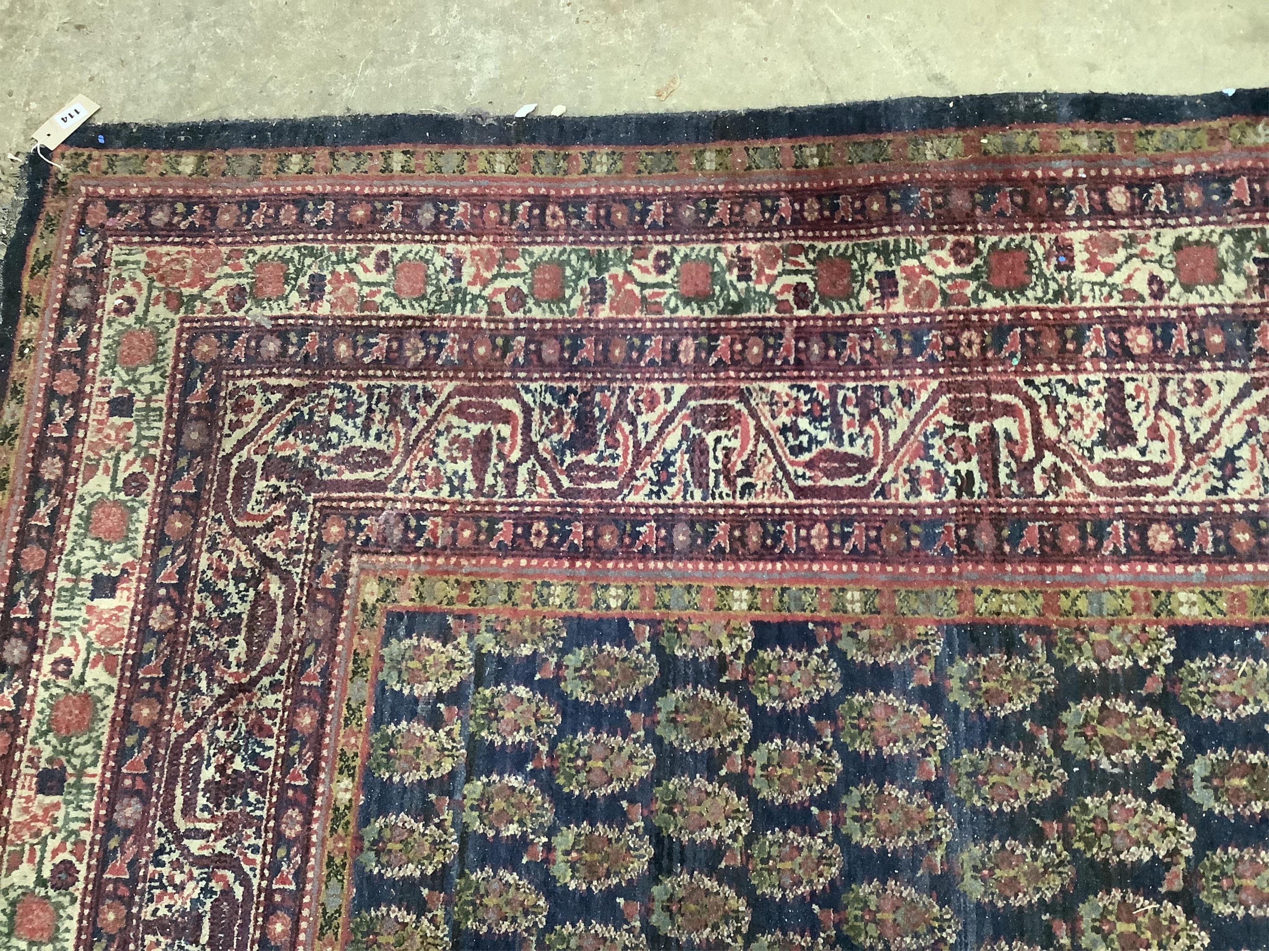 A Serabend blue ground boteh carpet, approximately 406 x 334cm. Condition - poor